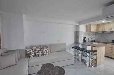 a living room with a couch and a kitchen at Gold Emerging Villas Ltd Apart 5 in Ayia Napa