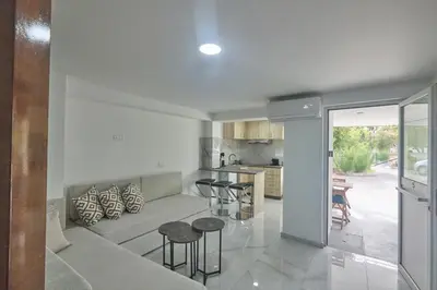 a living room with a couch and a kitchen at Gold Emerging Villas Ltd Apart 5 in Ayia Napa