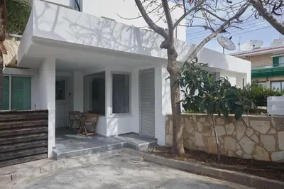 a white house with a stone wall at Gold Emerging Villas Ltd Apart 5 in Ayia Napa