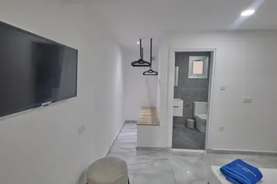 a white room with a tv and a bathroom at Gold Emerging Villas Ltd Apart 5 in Ayia Napa