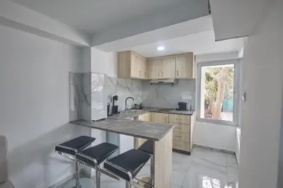 a kitchen with a counter and stools in it at Gold Emerging Villas Ltd Apart 5 in Ayia Napa