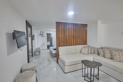 a living room with a white couch and a tv at Gold Emerging Villas Ltd Apart 5 in Ayia Napa