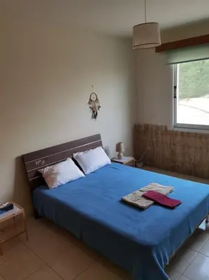 a bedroom with a blue bed with two towels on it at Lovely house apartment 2 bedrooms wiht nice view in Voroklini