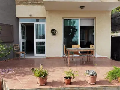 a patio with a table and chairs and plants at Lovely house apartment 2 bedrooms wiht nice view in Voroklini
