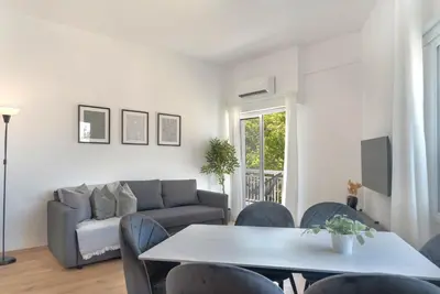 a living room with a couch and a table and chairs at Phaedrus Living City Breeze Residences Urbanity in Larnaka