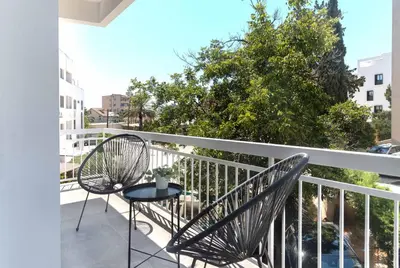 a balcony with two chairs and a table at Phaedrus Living City Breeze Residences Urbanity in Larnaka