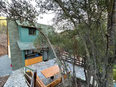 a house with a bench in front of it at Warm Family Glamping Cabin with Kids Playground in Arakapas