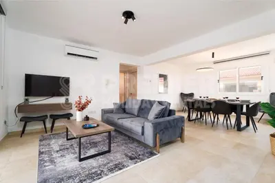 a living room with a couch and a table at Apartment Anabelle in Paralimni