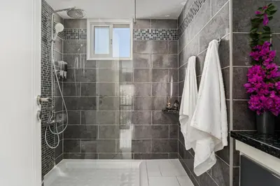 a bathroom with a tub and a shower with tiles at Ayia Napa Villa Jasmine Sirens Beach Dom na Cyprze in Ayia Napa