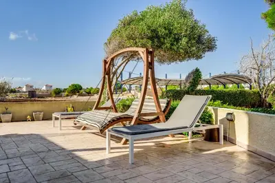 two chairs and a swing on a patio at Ayia Napa Villa Jasmine Sirens Beach Dom na Cyprze in Ayia Napa