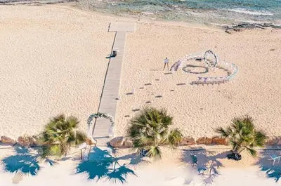 a sign on a beach with palm trees and the ocean at Ayia Napa Villa Jasmine Sirens Beach Dom na Cyprze in Ayia Napa