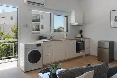 a kitchen with a sink and a dishwasher at Phaedrus Living City Breeze Residences Grace in Larnaka