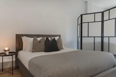a bedroom with a bed with pillows on it at Phaedrus Living City Breeze Residences Grace in Larnaka