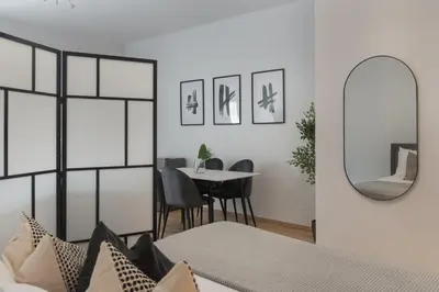 a living room with a table and a mirror at Phaedrus Living City Breeze Residences Grace in Larnaka
