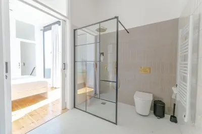 a glass shower in a bathroom with a toilet at 1924 Gemini House Jacuzzi, Garden, Rooftop in Nicosia