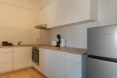 a kitchen with white appliances and white cabinets at Phaedrus Living City Breeze Residences Finesse in Larnaka