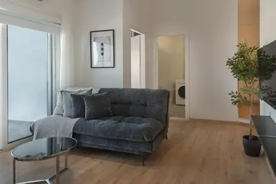 a living room with a couch and a glass table at Phaedrus Living City Breeze Residences Finesse in Larnaka