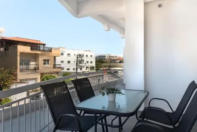 a table and chairs on a balcony with a view at Phaedrus Living City Breeze Residences Finesse in Larnaka