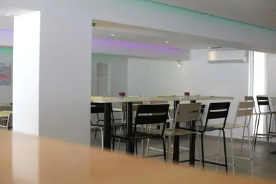 an empty room with a table and chairs at Sea CleoNapa Hotel in Ayia Napa