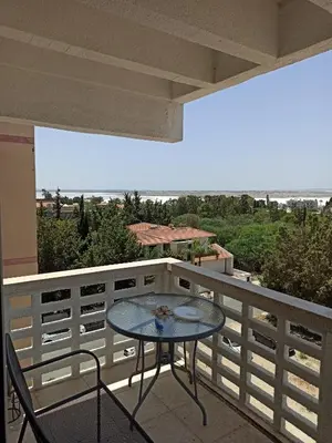 a table and chairs on a balcony with a view at ideal famille panoramic view lac salé in Larnaka