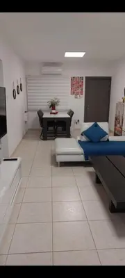 a living room with a bed and a table at ideal famille panoramic view lac salé in Larnaka