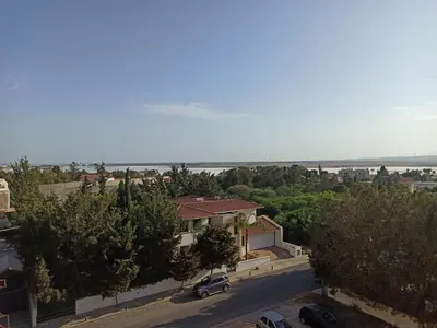 arial view of a house with a car parked in a street at ideal famille panoramic view lac salé in Larnaka