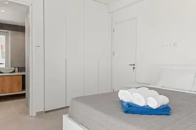 a bedroom with a bed with four rolled towels at Serenity Waves Villa 19 in Larnaka