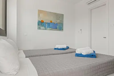 a bedroom with two beds with towels on them at Serenity Waves Villa 19 in Larnaka