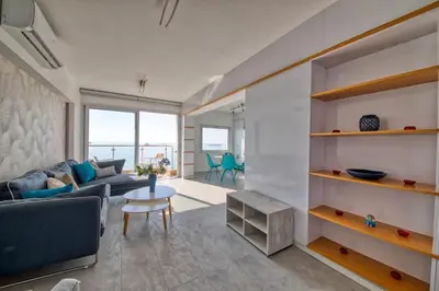 a living room with a couch and a table at Limassol Molos Hawaii Royal - Front-line 2 bedroom in Limassol