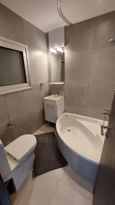 a bathroom with a tub and a toilet and a sink at Limassol Molos Hawaii Royal - Front-line 2 bedroom in Limassol