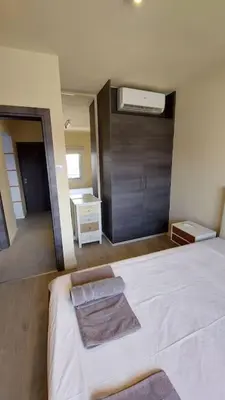 a bedroom with a white bed and a bathroom at Limassol Molos Hawaii Royal - Front-line 2 bedroom in Limassol