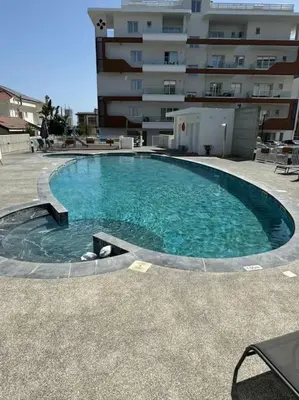 a large swimming pool in front of a building at Limassol Beautiful Apartment in Limassol