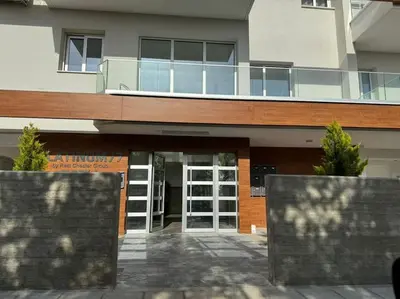 a building with a glass door and a balcony at Limassol Beautiful Apartment in Limassol