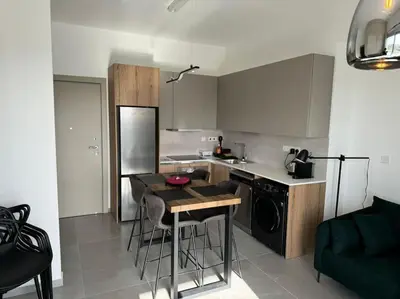 a kitchen with a table and a counter top at Limassol Beautiful Apartment in Limassol