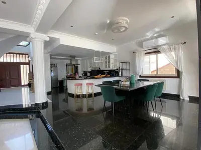 a kitchen with a table and green chairs in it at Beachfront villa Meneou in Meneou