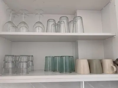 a shelf filled with glasses and vases at Marina view seaside apartment in Larnaka