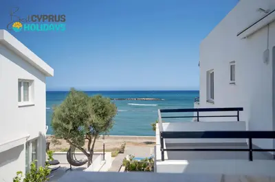 a view of the ocean from the balcony of a house at Sea Front Luxury Apartment in Voroklini