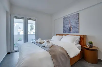 a bedroom with a bed with two stuffed animals on it at Sea Front Luxury Apartment in Voroklini