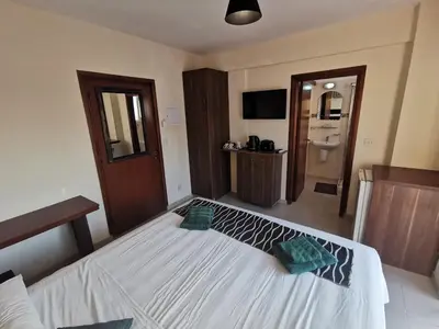a bedroom with a large white bed in a room at DownTown Studios & Two-Bedrooms in Larnaka