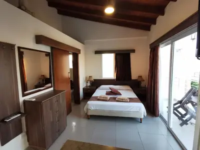 a bedroom with a bed and a large window at DownTown Studios & Two-Bedrooms in Larnaka