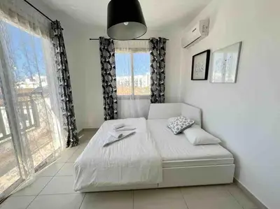a bedroom with a bed and a large window at Thaleia Suite - Tourism License 3119 in Protaras