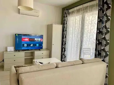 a living room with a couch and a television at Thaleia Suite - Tourism License 3119 in Protaras