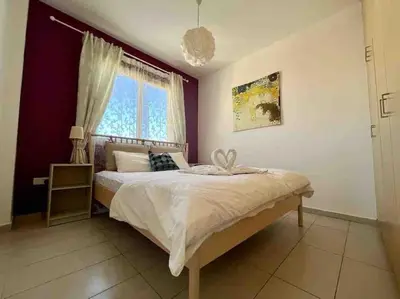 a bedroom with a large bed and a window at Thaleia Suite - Tourism License 3119 in Protaras