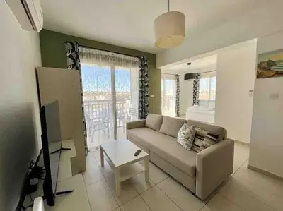 a living room with a couch and a table at Thaleia Suite - Tourism License 3119 in Protaras