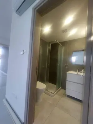 a bathroom with a toilet and a shower and a sink at Luxury 2 bedroom apartment in Larnaka
