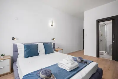 a bedroom with a large bed with towels on it at Paradise Apartment with Private Pool & Sea View in Larnaka