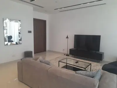 a living room with a couch and a flat screen tv at 360 Building - City View 2 Bedroom Residence in Nicosia
