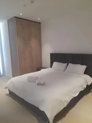 a bedroom with a large white bed with towels on it at 360 Nicosia-2 Bedroom City Tower in Nicosia