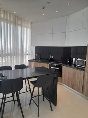 a kitchen with a table and chairs in it at 360 Nicosia-2 Bedroom City Tower in Nicosia