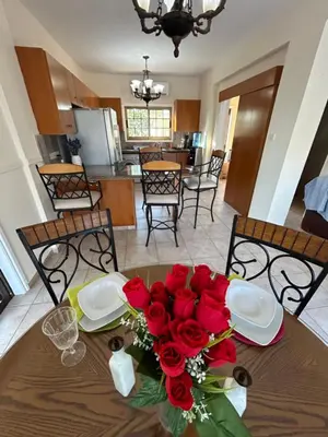 a table with a bouquet of red roses on it at Ayia Napa Marina Luxury Villas - Diamond in Ayia Napa